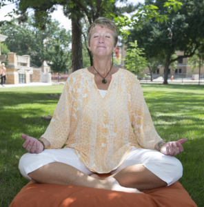 Close Up of Deb Hendricks on a cushion under a tree